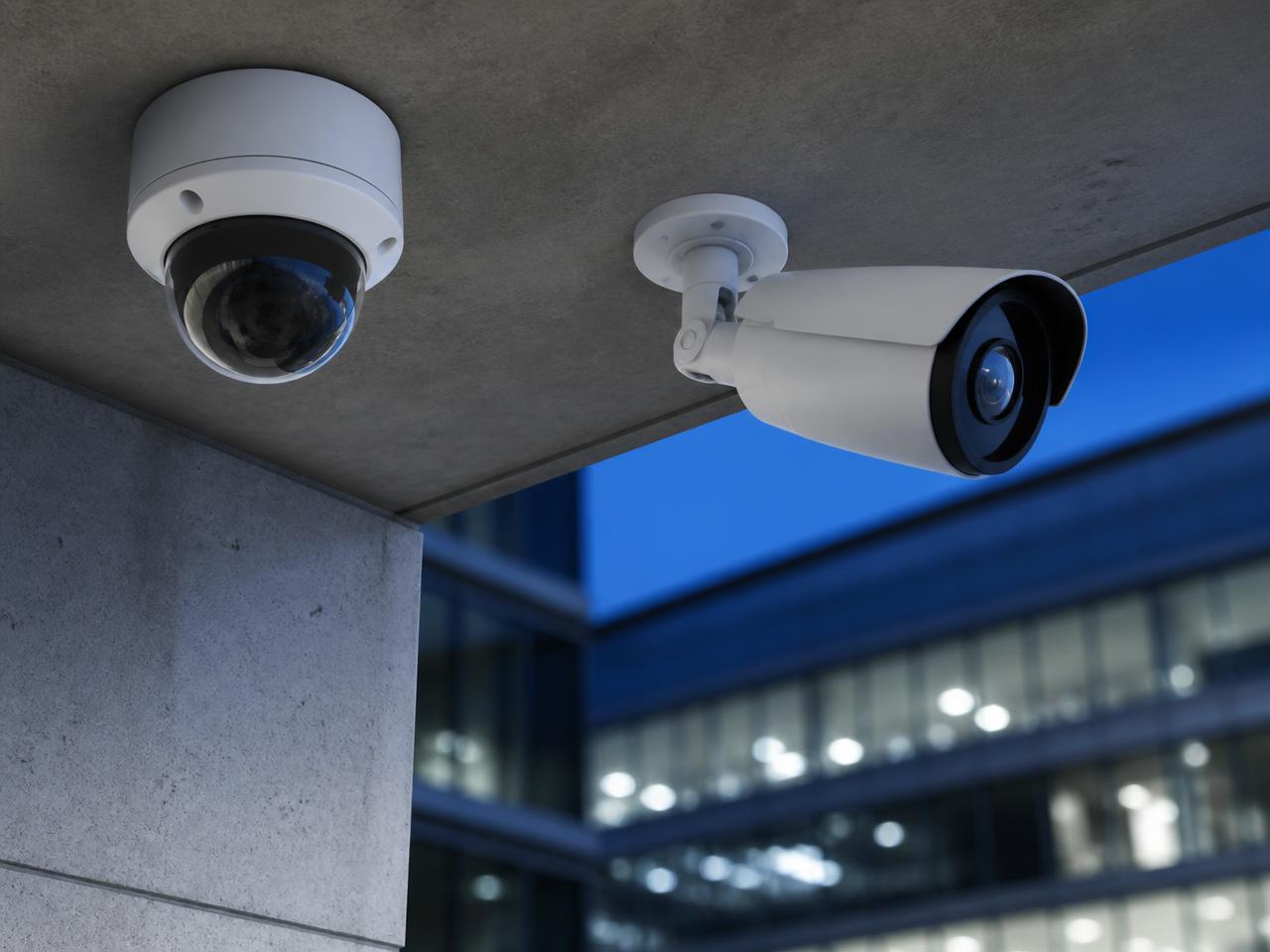 Professional IP dome and turret surveillance cameras installed on a commercial building